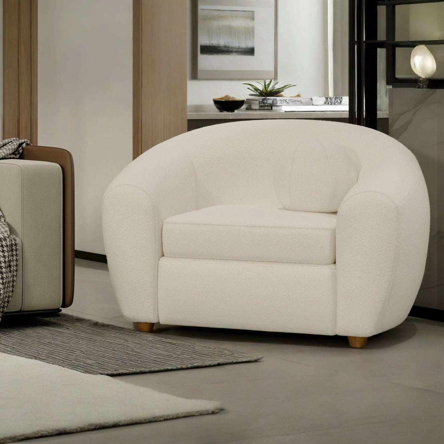 White armchair in a living room setting with a neutral color palette.