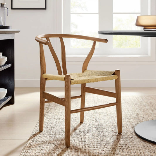 Scandinavian-style wishbone chair in walnut finish in a living room with a rug underneath